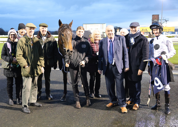 Members in a parade ring with a jockey in Elite Racing Club silks